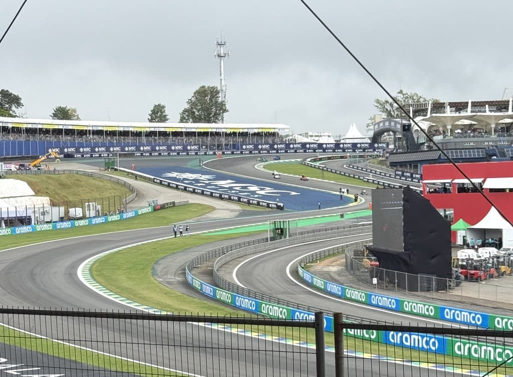The Senna S at Interlagos seen from the grandstand, with safety fencing in the foreground.