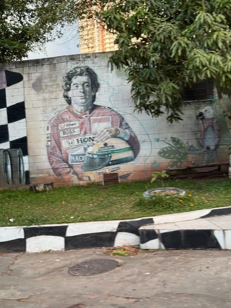 History of Autodromo Jose Carlos Pace Ayrton Senna mural showing the Brazilian driver holding his yellow helmet.