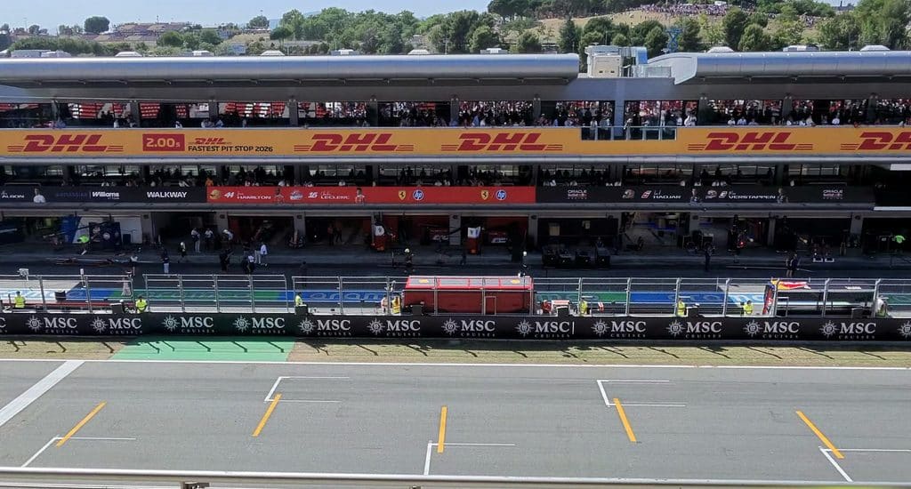 Formula 1 sponsorship  DHL banners above the Ferrari and Red Bull garages, with MSC Cruises branding along Barcelona’s pit wall.