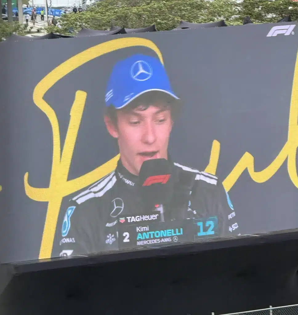 Kimi Antonelli in Mercedes team clothing appears on the big screen at Interlagos.