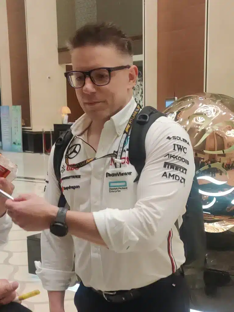 Lewis Hamilton Paintball Story Peter Bonnington signs an autograph while wearing a white Mercedes team shirt in China in 2024.