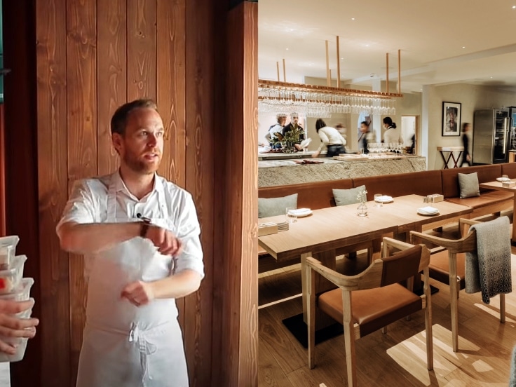 Exclusive Restaurants Interior of Frantzén in Stockholm with a chef in the dining room and the open kitchen visible behind the tables.