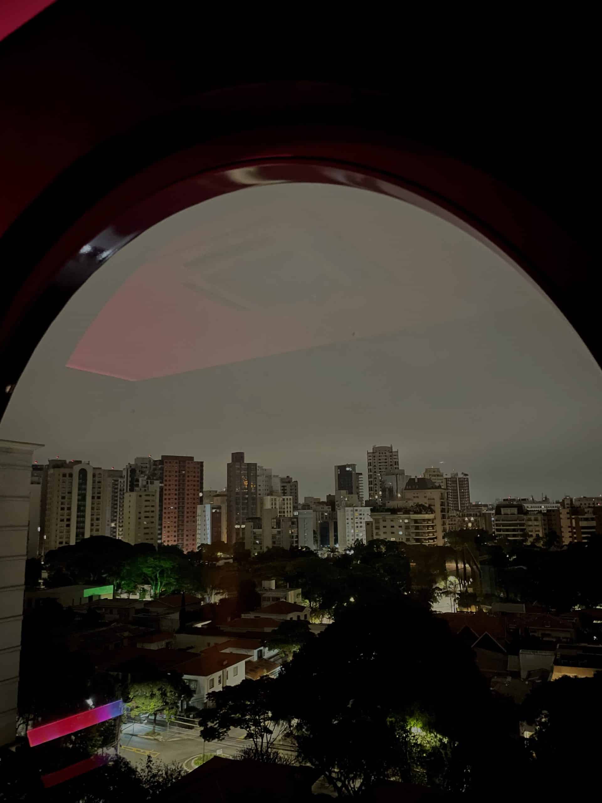 São Paulo skyline viewed through a circular window at Hotel Unique.