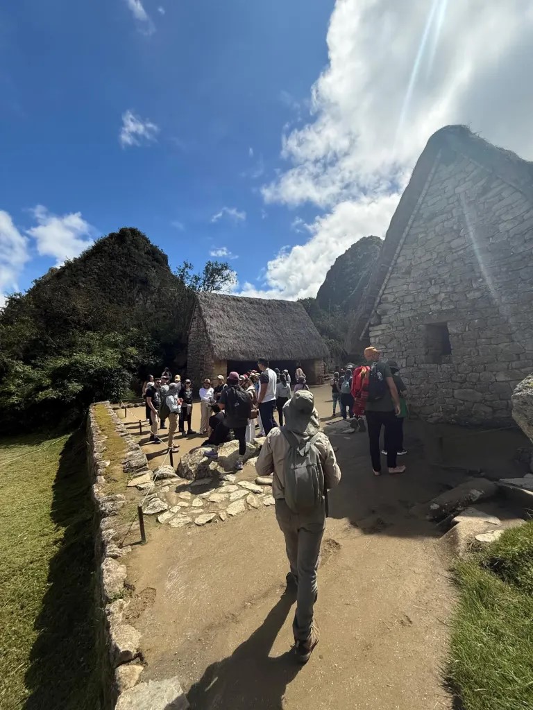 Visitors walking through the historic stone ruins at Machu Picchu in Peru