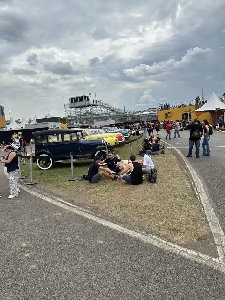 São Paulo Travel Story:  Visitors relaxing beside a vintage vehicle display in the Interlagos fan zone.