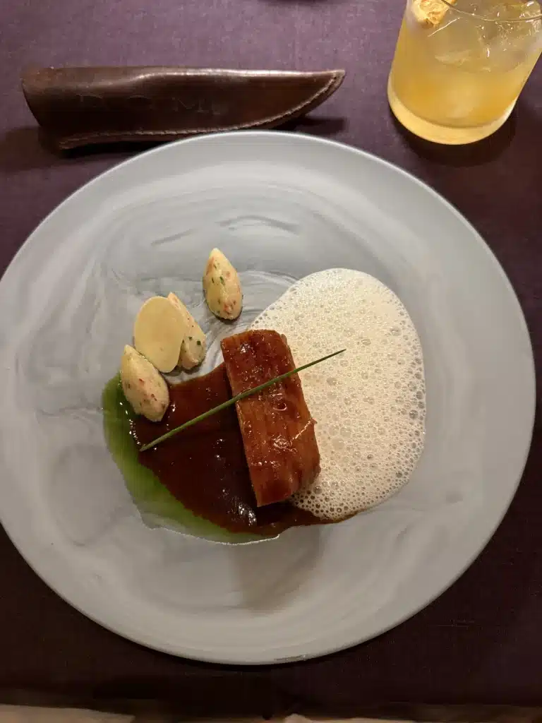Richard Jarocki A carefully plated course with green and pale sauces on a large gray plate at D.O.M. in São Paulo.