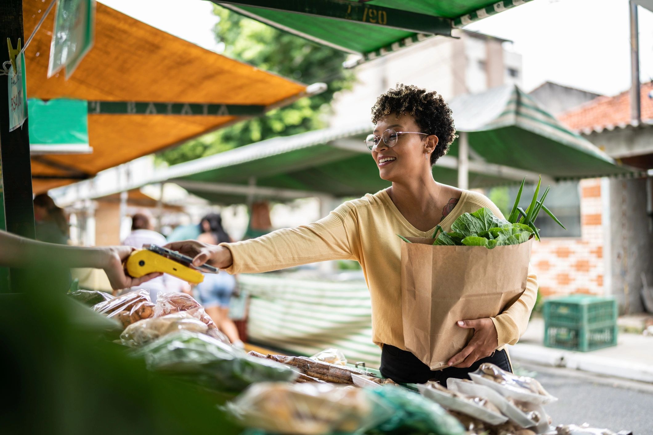 Traveler making a purchase at a lively street market