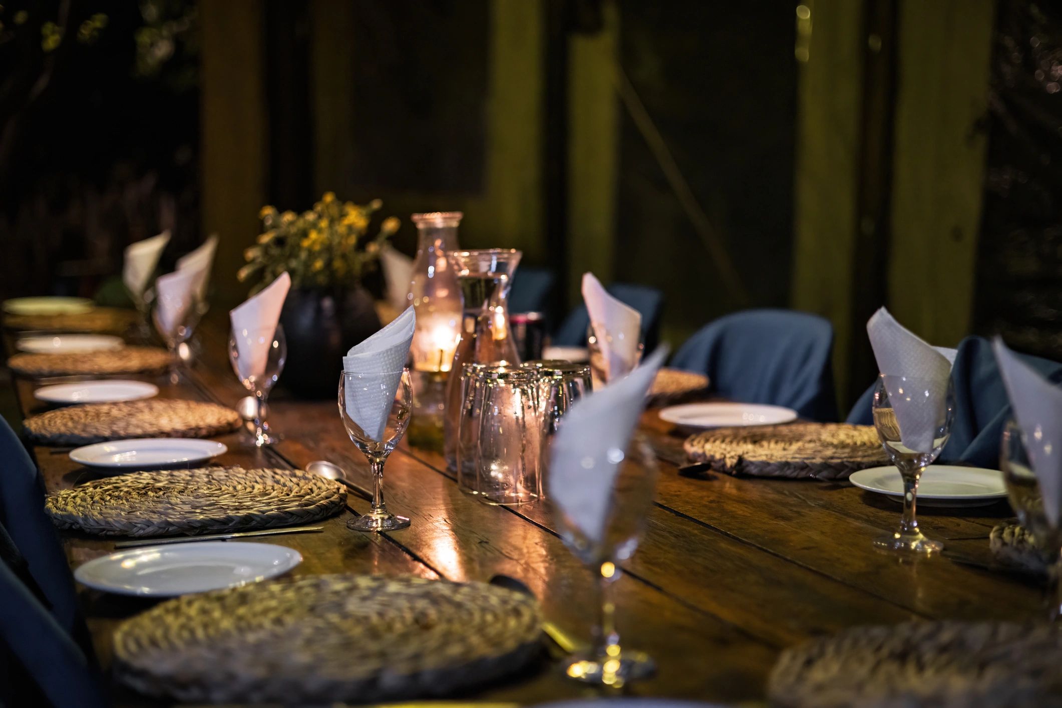 Elegant candlelit dining table prepared for dinner