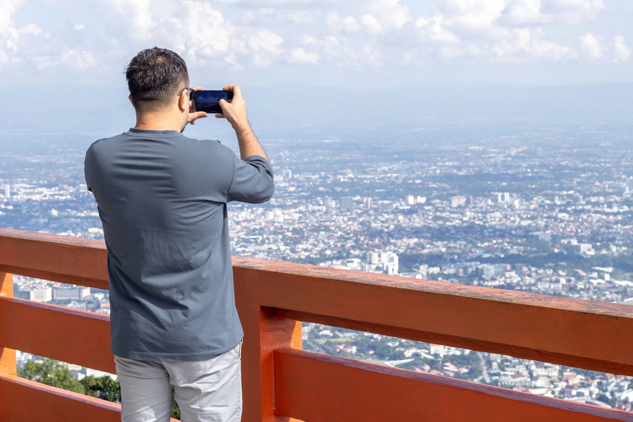 Traveler photographing a panoramic city view