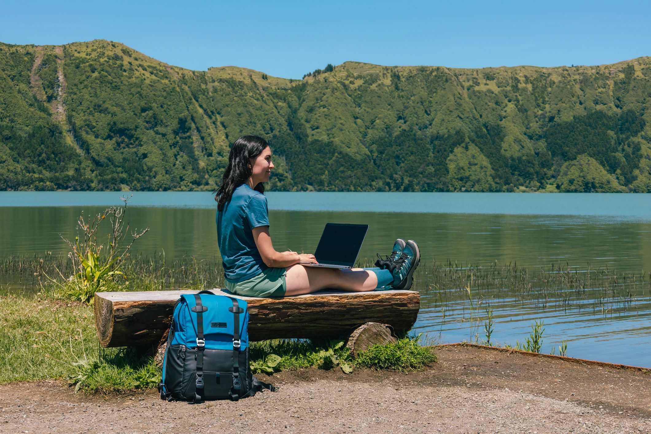 Remote travel creator working by a scenic lake