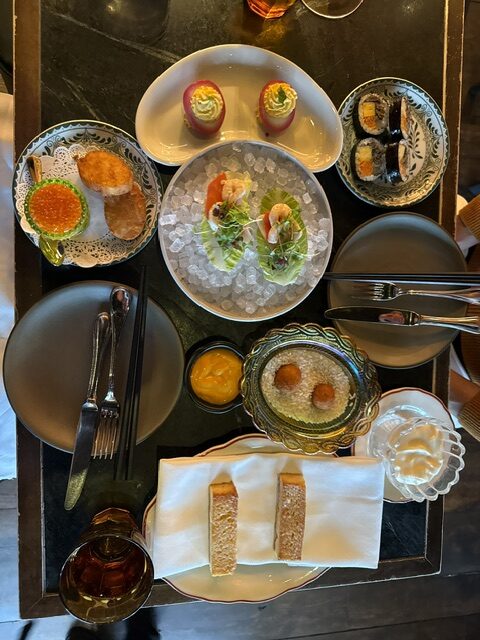 Opening appetizers from The Brucket List brunch at COQODAQ in New York City, featuring Korean-inspired seafood, small bites, fresh bread, and elegant table presentation.