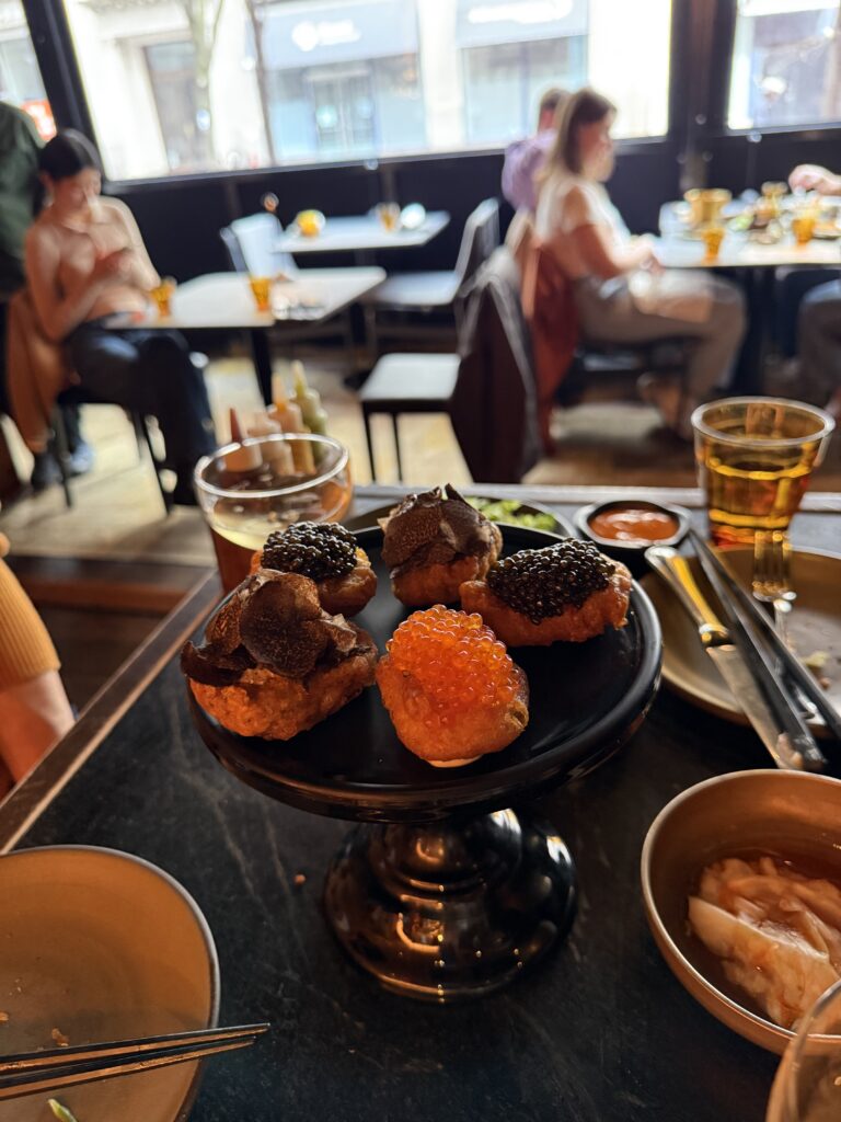 COQODAQ's Golden Nuggets topped with Tsar Imperial® Daurenki caviar, seasonal truffle, and ocean trout roe in New York City.