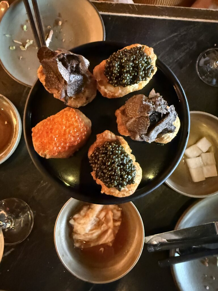 COQODAQ's Golden Nuggets topped with Tsar Imperial® Daurenki caviar, seasonal truffle, and ocean trout roe in New York City.
