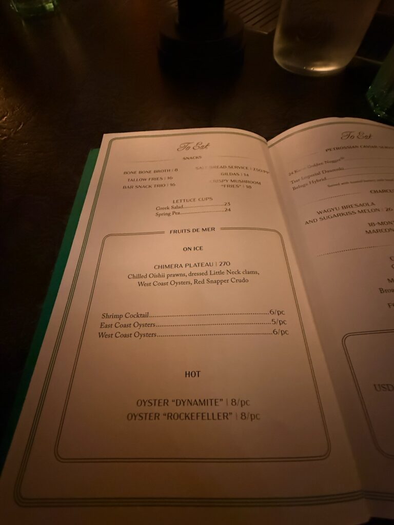 The food menu at the Whiskey Bar inside Bar Chimera at 550 Madison in New York City, featuring oysters, seafood, and bar snacks.