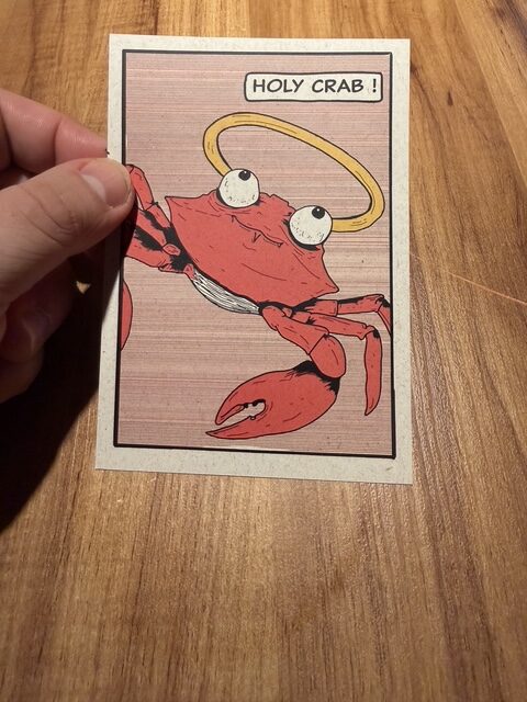 Illustrated “Holy Crab” tasting-menu card featuring a red crab at Evvai São Paulo