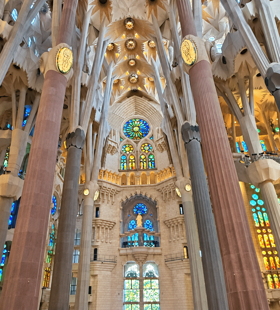 Food-Focused Trips Tall columns and stained-glass windows inside Sagrada Família in Barcelona.