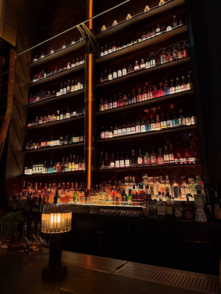 The Whiskey Bar at Bar Chimera inside 550 Madison in New York City, featuring an extensive collection of premium whiskey and spirits.