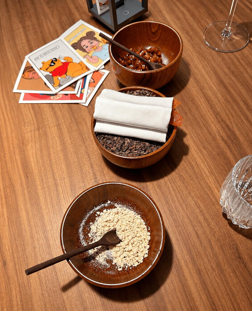 Food-Focused Trips Table setting, illustrated cards and dishes during a meal at Evvai in São Paulo.