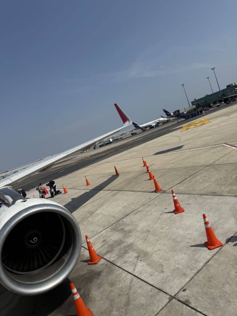 View of an airplane wing and jet engine before departure to a new destination