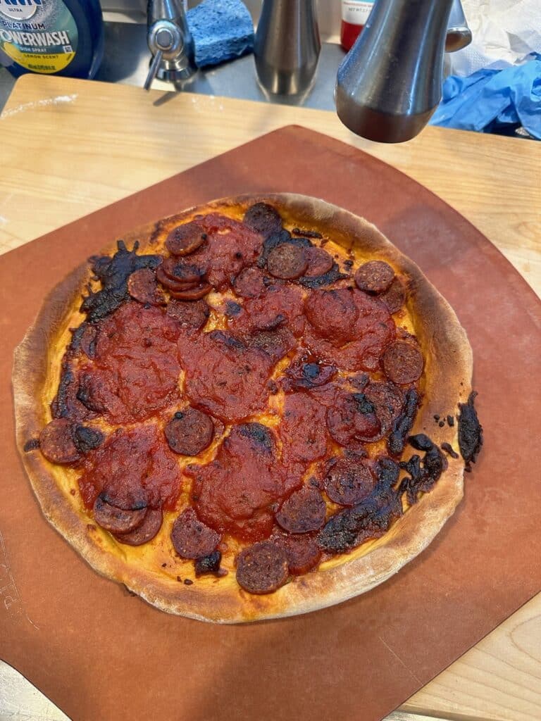 Homemade pepperoni and sausage pizza with a browned crust
