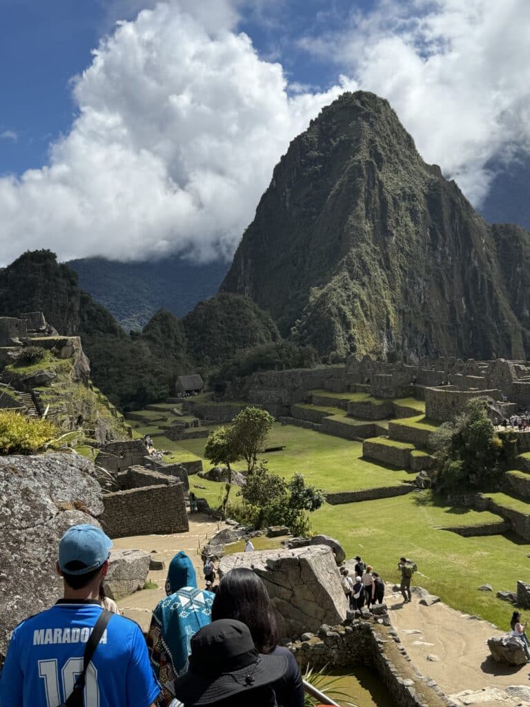 Machu Picchu ruins and Huayna Picchu mountain beneath dramatic clouds in Peru