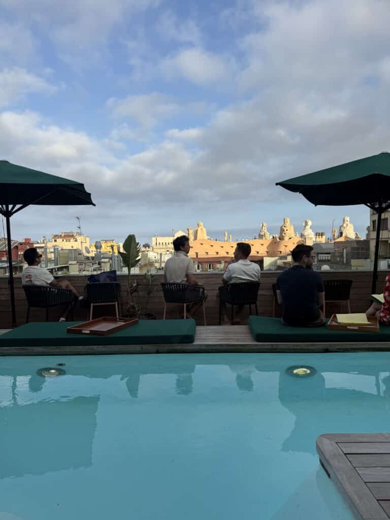 Rooftop pool and lounge seating at Sir Victor in Barcelona, with Casa Milà beyond