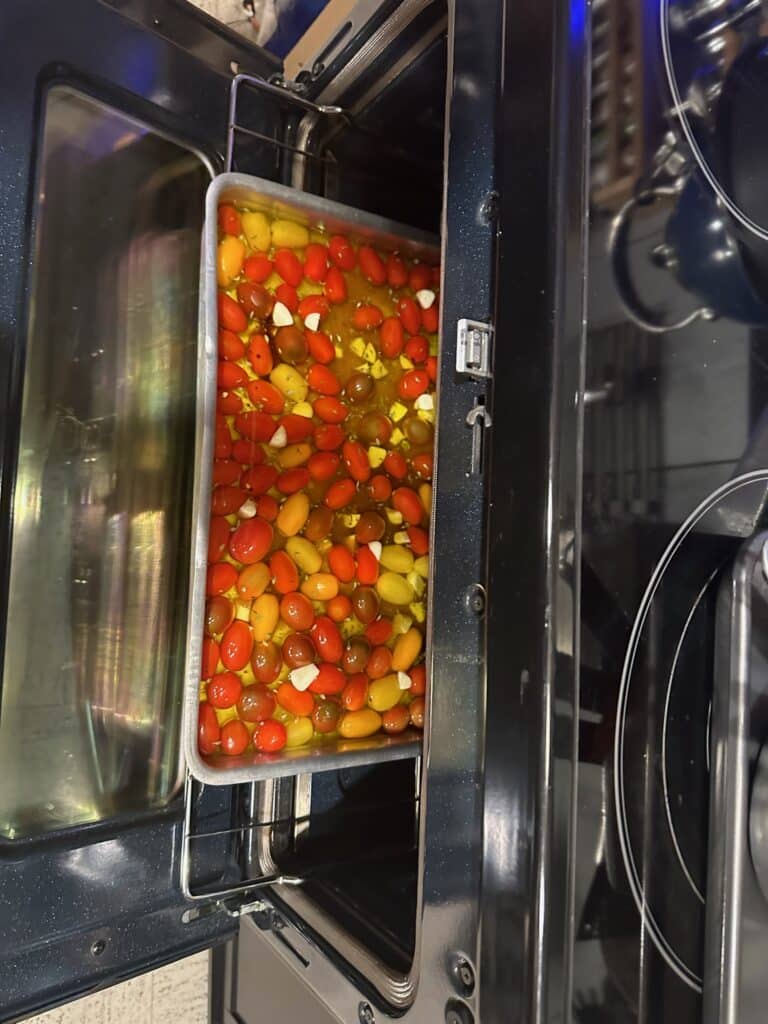 Tomatoes cooking in olive oil with garlic and herbs