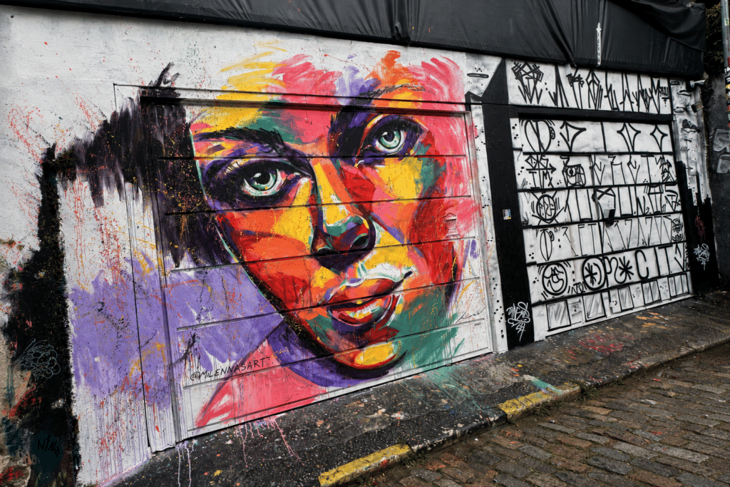 São Paulo Travel Guide Colorful portrait mural by Milenna Sart at Beco do Batman in São Paulo.