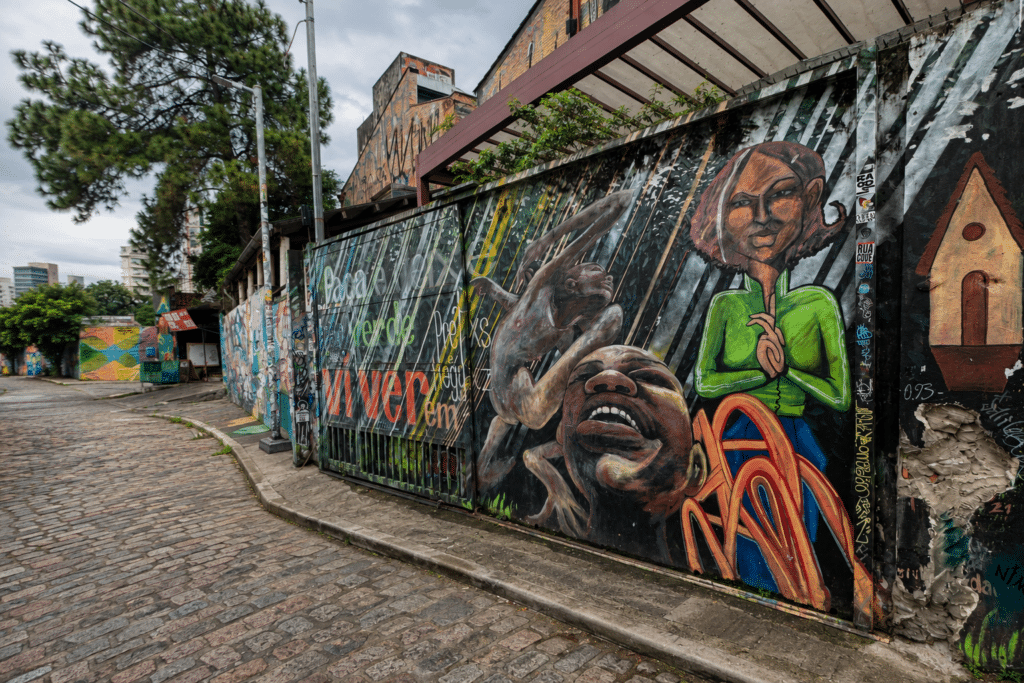 São Paulo Travel Guide Colorful murals along a cobblestone street at Beco do Batman in São Paulo.