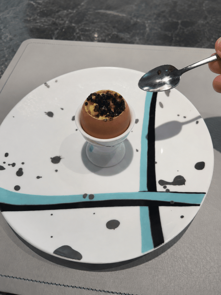 Scrambled egg topped with Ossetra caviar served in an eggshell at the Blue Box Café in New York City