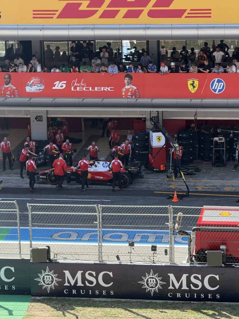 Ferrari mechanics working around Charles Leclerc’s Formula 1 car outside the garage at the 2025 Barcelona Grand Prix