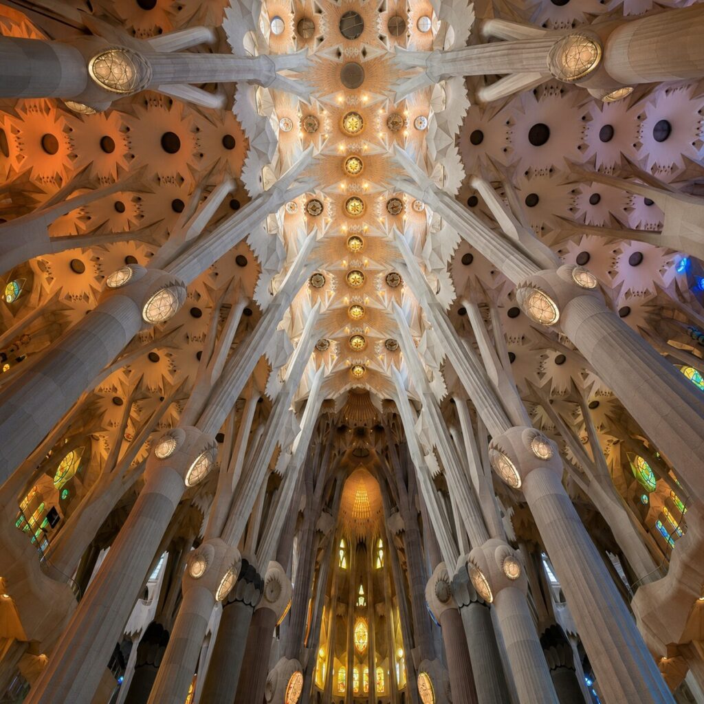Branching columns and illuminated ceiling inside Sagrada Família in Barcelona