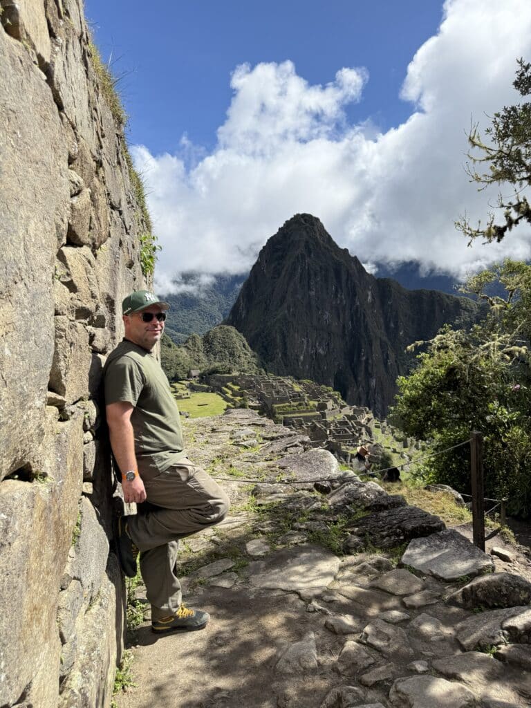 Richard Jarocki overlooking the ruins and mountains of Machu Picchu in Peru