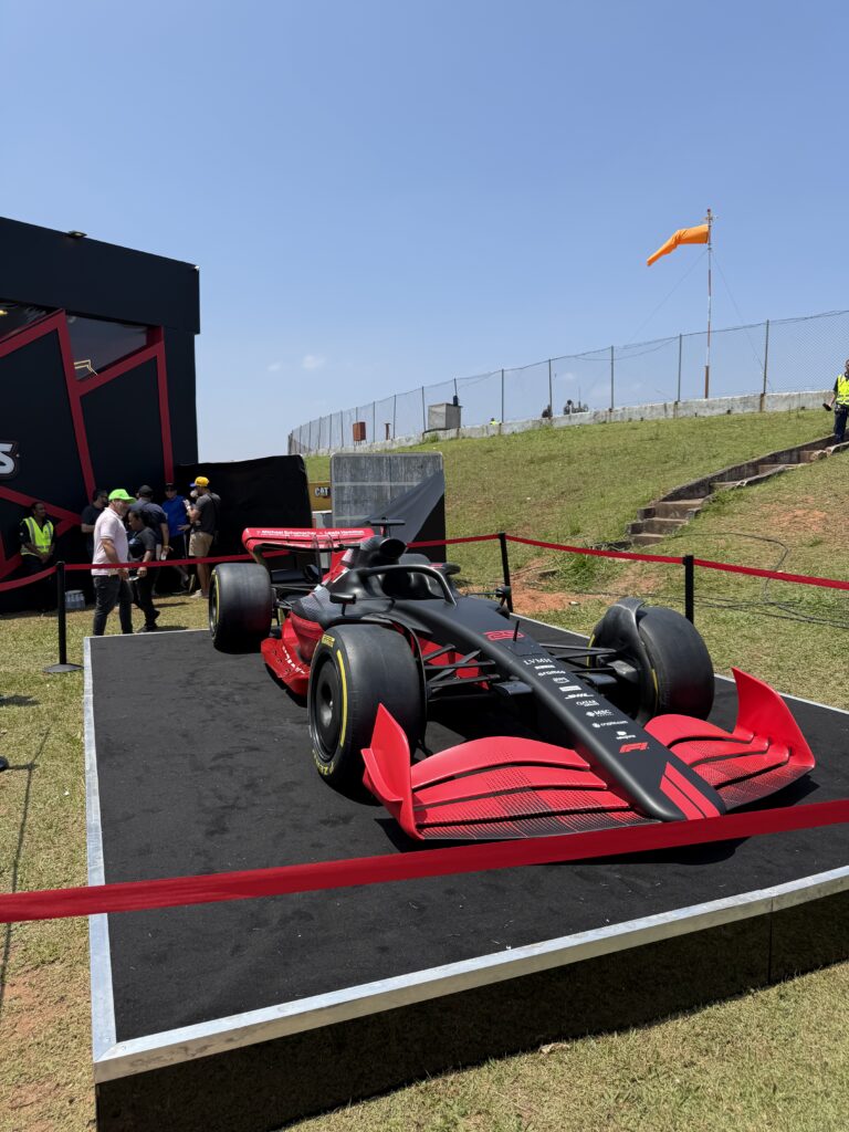 Black and red Formula 1 show car displayed at Interlagos during the 2025 São Paulo Grand Prix