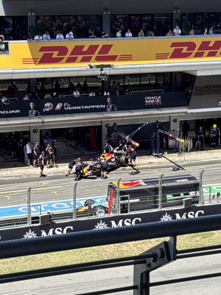 Red Bull mechanics working on Max Verstappen’s Formula 1 car in the pit box at the 2025 Barcelona Grand Prix