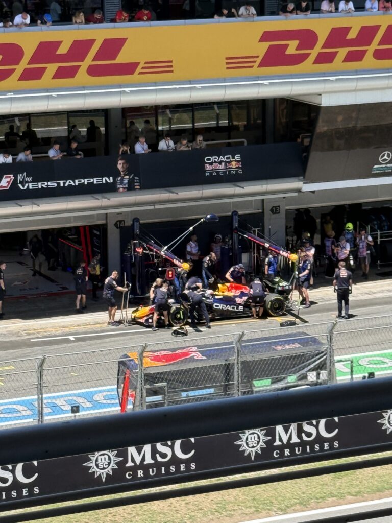 Max Verstappen’s Red Bull Formula 1 car being serviced in the pit lane at the 2025 Barcelona Grand Prix