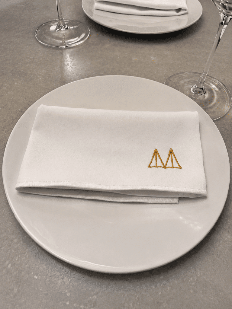 Mont Bar place setting with an embroidered napkin inside the Barcelona restaurant