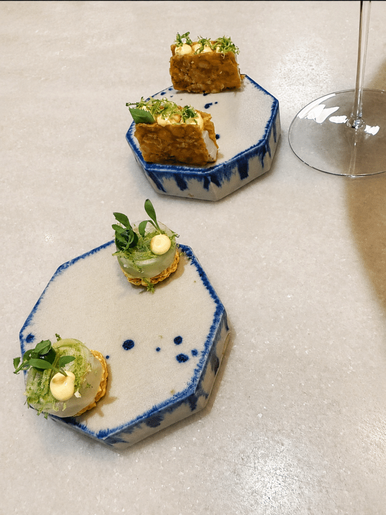 Opening snacks served on blue-and-white ceramics at Mont Bar Barcelona