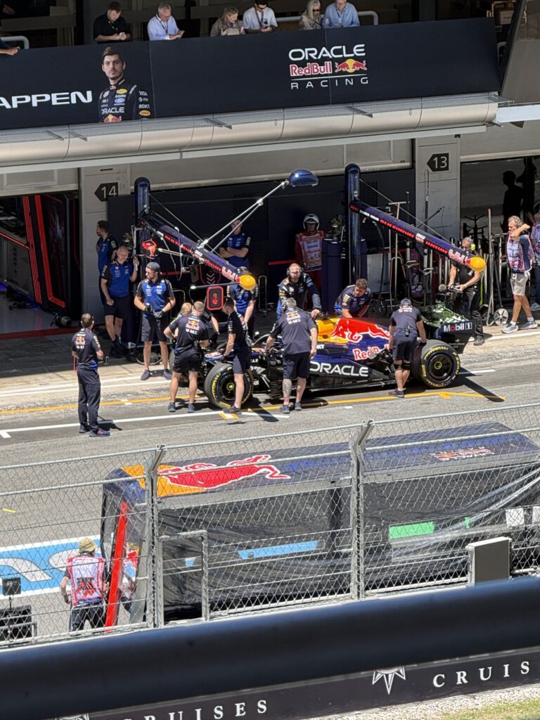 Red Bull mechanics preparing Max Verstappen’s Formula 1 car outside the team garage at the 2025 Barcelona Grand Prix