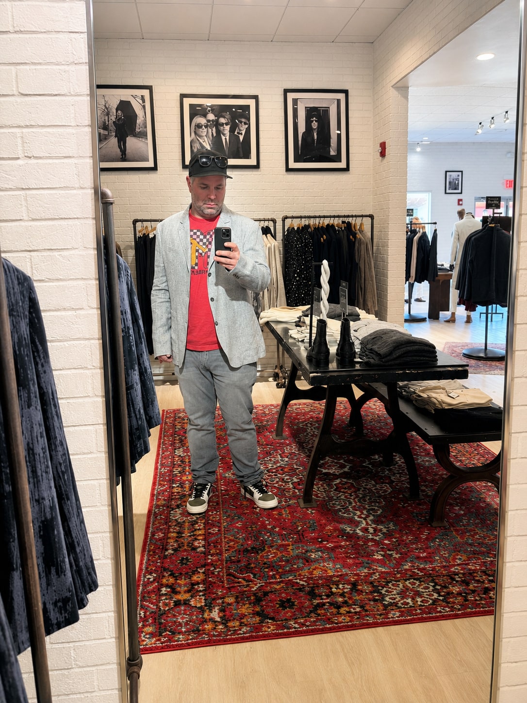 Richard Jarocki in a gray suit and MTV shirt inside a John Varvatos boutique.