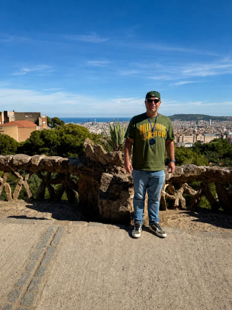 About Richard Jarocki standing at Park Güell with the Barcelona skyline and Mediterranean Sea in the background.