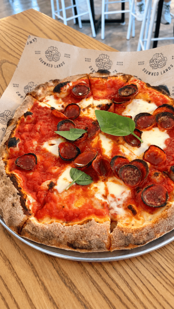 Pepperoni pizza with fresh mozzarella, tomato sauce and basil at Drowned Lands Brewery.