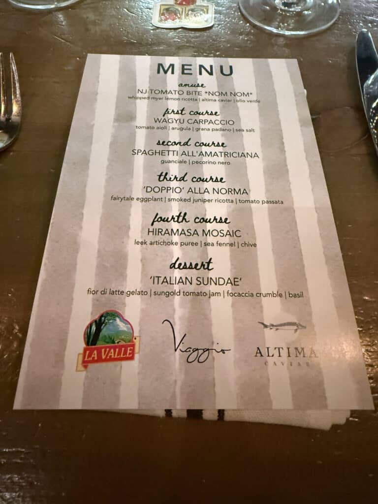 Viaggio x La Valle Close view of the dinner menu showing dish ingredients and the La Valle, Viaggio and Altima Caviar logos.