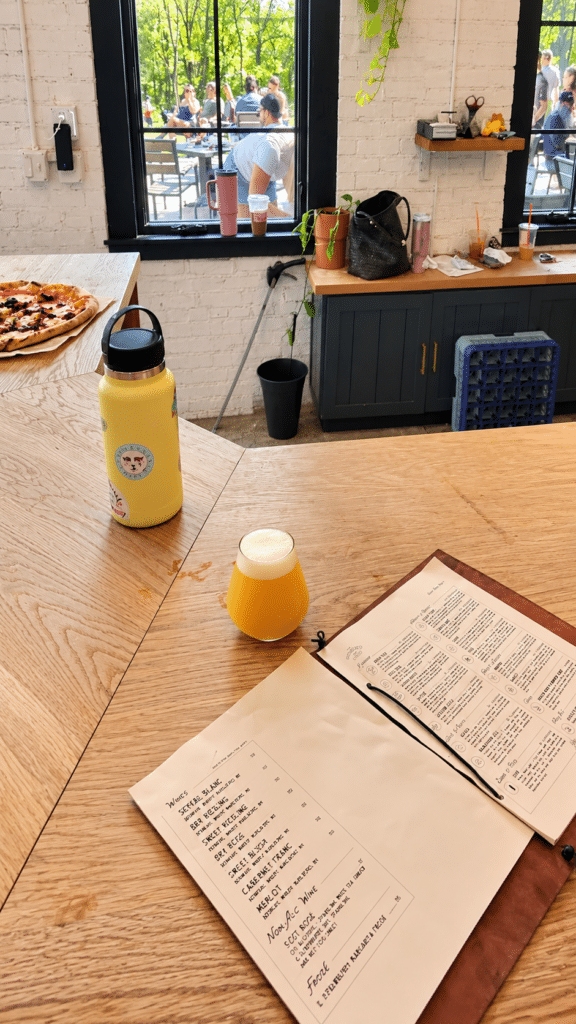 Wooden bar counter with menus where guests order beer at Drowned Lands Brewery
