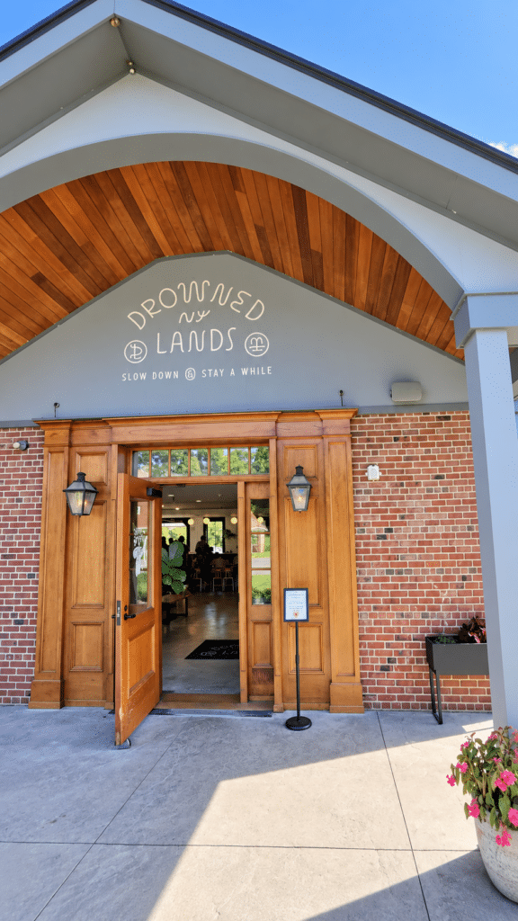 Wooden entrance doors beneath the Drowned Lands Brewery sign.
