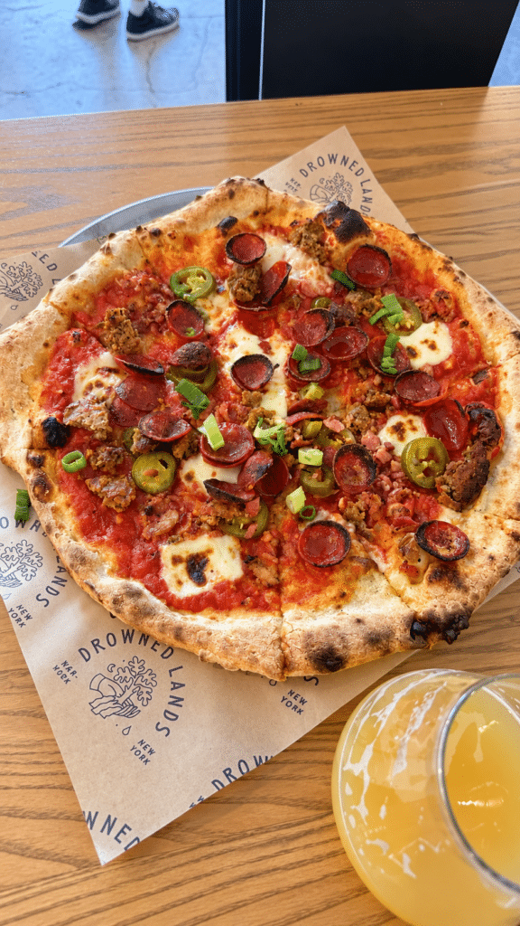 Hometown Fav pizza with pepperoni, bacon, sausage, pickled jalapeños and scallions at Drowned Lands.