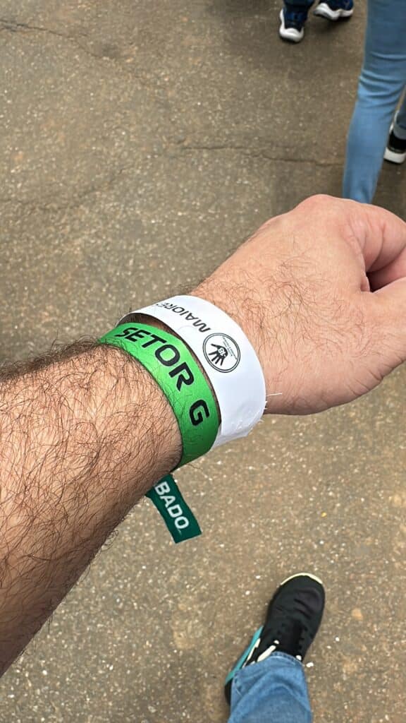 Why I Love Formula 1 Close-up of Richard’s wrist with a green Setor G wristband and a white age-verification wristband.