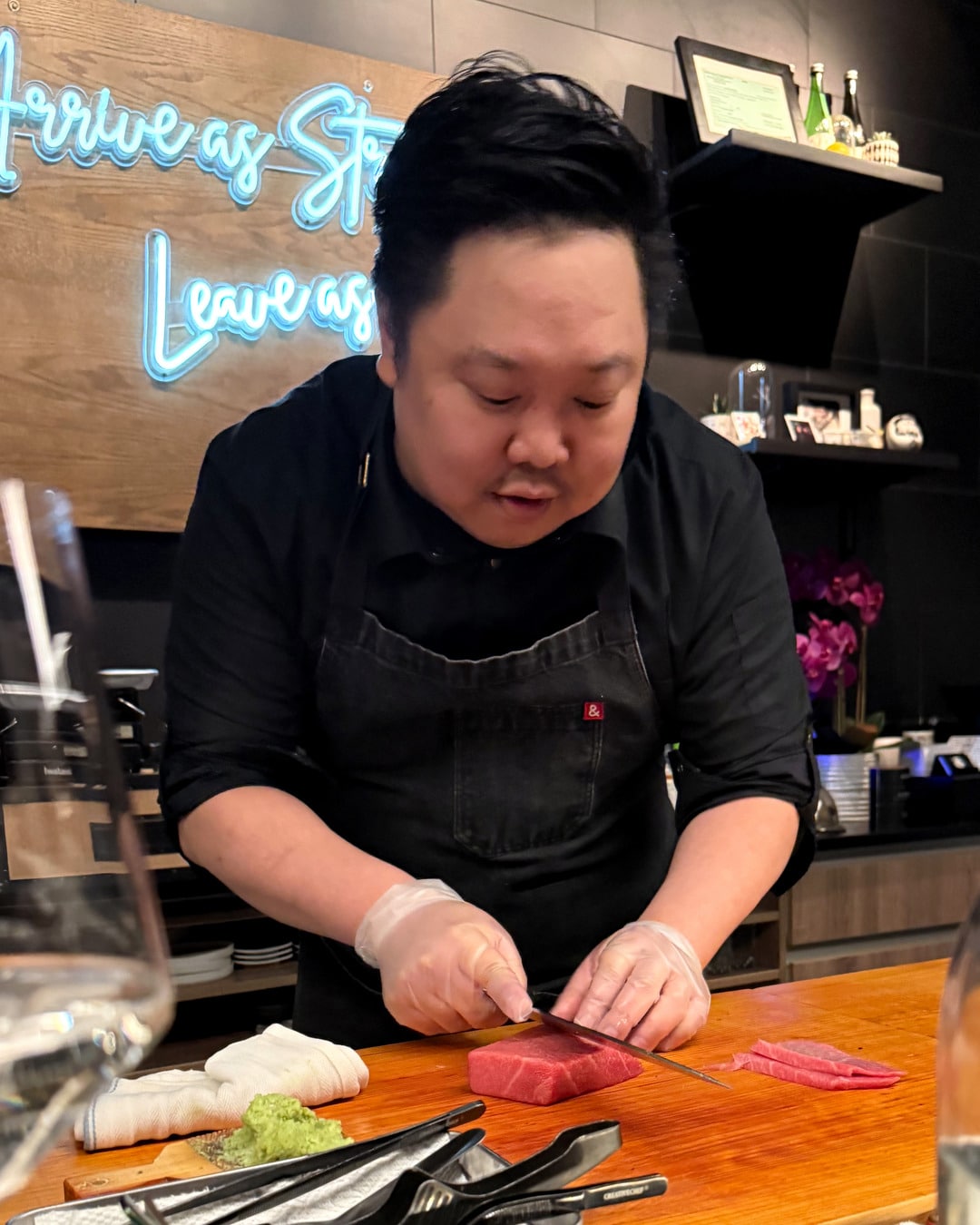 Chef slicing tuna at the Sushi by Sea counter in Ridgefield, New Jersey.