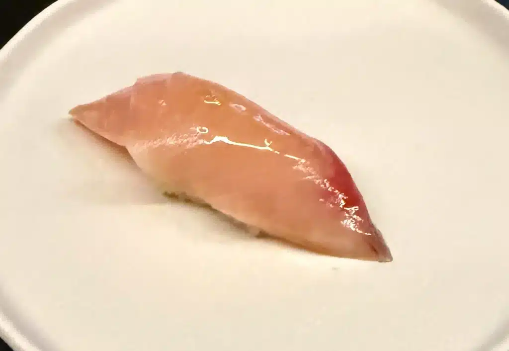 Sushi by Sea Review Glossy, pale-pink hamachi nigiri tapering to a pointed end.