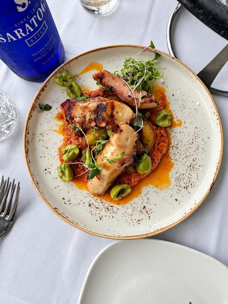 Blu Pointe Charred Octopus with potatoes, broken olives and romesco